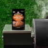 A packet of Pit Boss Sweet Heat Brown Sugar Rub sits on a grill, suggesting a delicious grilling experience.