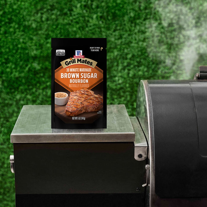 A packet of Pit Boss Sweet Heat Brown Sugar Rub sits on a grill, suggesting a delicious grilling experience.