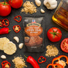 A packet of McCormick Grill Mates Brown Sugar Bourbon seasoning is surrounded by fresh ingredients like tomatoes, garlic, and peppers.