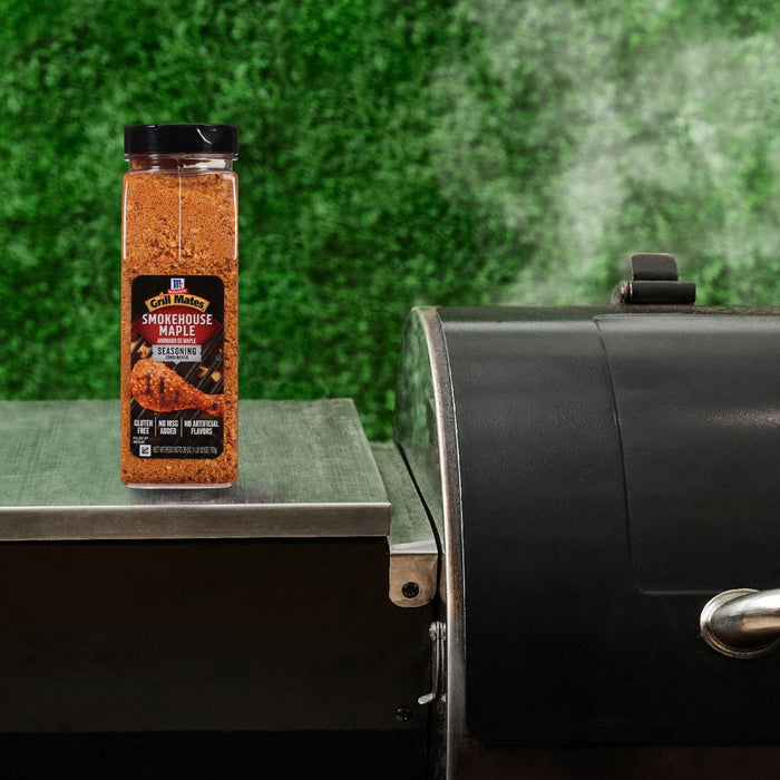 A container of Kosmos Q Dirty Bird BBQ Rub sits on a grill, suggesting its use in outdoor cooking.