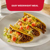 The image displays two packets of Mccormick Taco Seasoning Mix, featuring the text "AMP UP TACO CASSEROLE, WINGS, BURGERS AND MORE" against a red background.