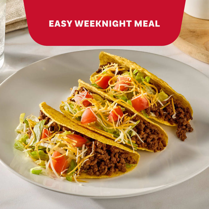 The image displays two packets of Mccormick Taco Seasoning Mix, featuring the text "AMP UP TACO CASSEROLE, WINGS, BURGERS AND MORE" against a red background.