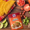 McCormick Taco Seasoning Mix with a taco tomatoes limes cilantro and cheese.