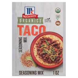A packet of Mccormick Organics Regular Taco Seasoning Mix 1 Oz is shown with a serving suggestion of a finished taco in a red bowl.