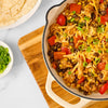A delicious skillet of chicken taco filling, made with ingredients like black beans, corn, and peppers and seasoned with Mccormick Organics Regular Taco Seasoning Mix 1 Oz, is shown ready to be served with tortillas and fresh toppings.
