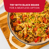 A close-up of a delicious skillet meal featuring chicken, black beans, corn, and cheese, prepared with Mccormick Organics Regular Taco Seasoning Mix 1 Oz, and a suggestion to try a meatless version.