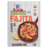 A packet of Mccormick Organics Regular Fajita Seasoning Mix 1 Oz is displayed in front of a red skillet filled with cooked chicken and vegetable fajitas, highlighting its use.