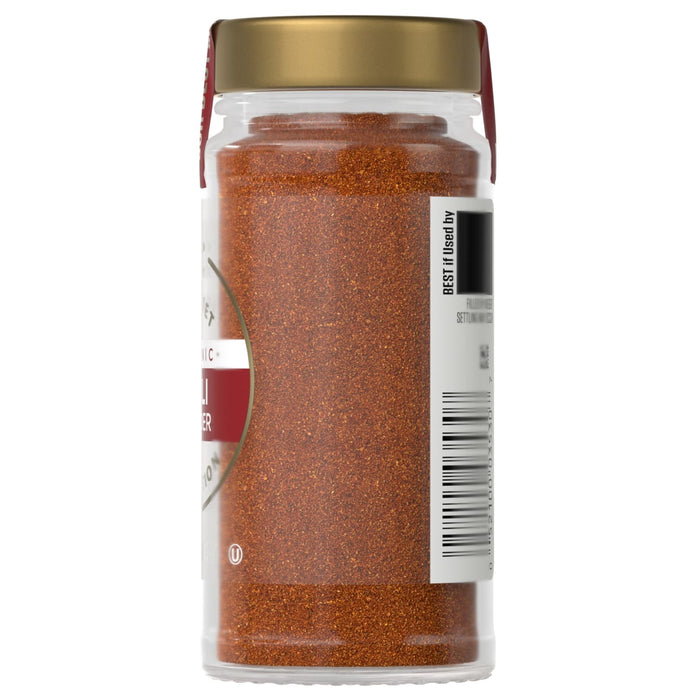 A jar of McCormick chili powder is displayed, showcasing its vibrant color and texture.