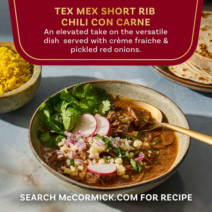 This is an image of McCormick's Tex Mex Short Rib Chili Con Carne, an elevated take on the versatile dish served with crème fraiche and pickled red onions.