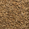A close-up of whole cumin seeds, showcasing their elongated shape and brown color.