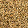 A close-up view of whole cumin seeds, showcasing their elongated shape and light brown color.