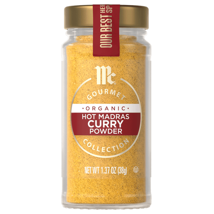 A jar of McCormick Gourmet Organic Hot Madras Curry Powder.