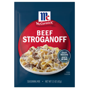 A blue and red packet of Mccormick Regular Beef Stroganoff Sauce Mix Envelope 1.5 Oz featuring a serving suggestion of creamy beef and noodles that can be prepared in 20 minutes.