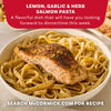 A bowl of lemon garlic and herb salmon pasta seasoned with Mccormick Garlic And Herb Pepper Seasoning Ground 4.37 Oz as part of a flavorful dinner recipe.