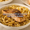 A seasoned salmon fillet rests atop a bowl of linguine pasta enhanced by Mccormick Garlic And Herb Pepper Seasoning Ground 4.37 Oz to provide a delicious pop of flavor.