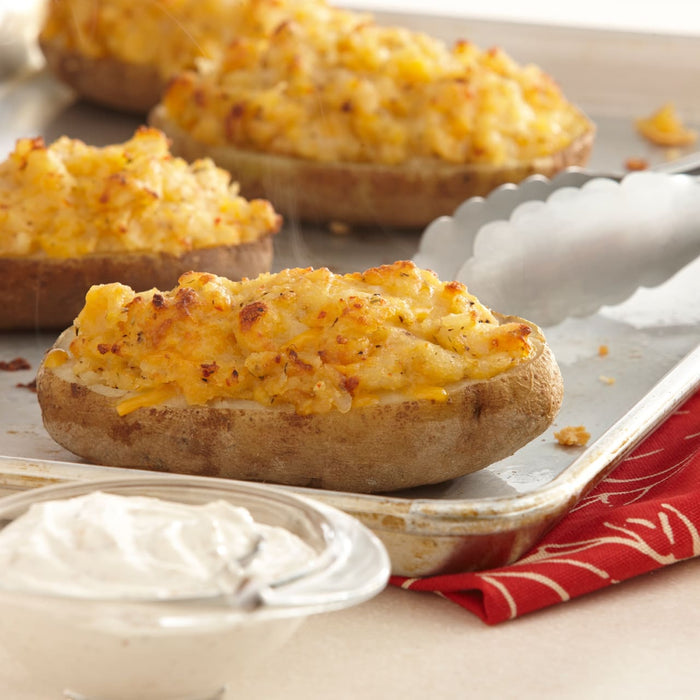 Freshly baked twice-baked potatoes are seasoned with Mccormick Signature Seasoning Savory Garlic Onion Oz and served with a side of creamy dipping sauce.
