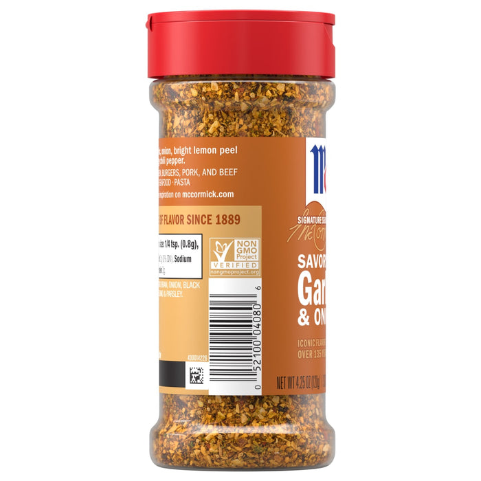 A clear plastic bottle of Mccormick Garlic Onion Pepper Seasoning Ground 4.25 Oz is shown against a white background, highlighting the coarse texture of the spice blend inside.