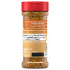 A clear plastic bottle of Mccormick Garlic Onion Pepper Seasoning Ground 4.25 Oz is shown from the back, displaying the nutrition facts, ingredients like sea salt, garlic, and onion, and the coarse texture of the seasoning blend through the container.
