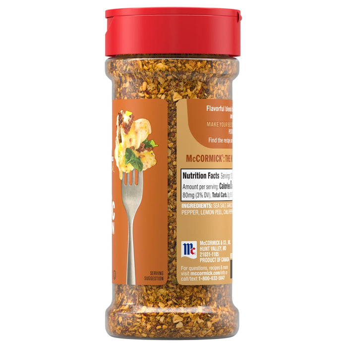 A side view of a bottle of Mccormick Garlic Onion Pepper Seasoning Ground 4.25 Oz displays the nutrition facts, ingredients, and a serving suggestion on a fork.