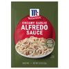 A green packet of Mccormick Creamy Garlic Alfredo Sauce Mix Envelope 1.25 Oz featuring a bowl of pasta with creamy sauce and chicken pieces.
