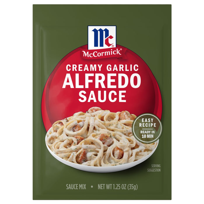 A green packet of Mccormick Creamy Garlic Alfredo Sauce Mix Envelope 1.25 Oz featuring a bowl of pasta with creamy sauce and chicken pieces.