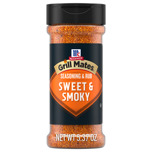A bottle of Mccormick Grill Mates Sweet And Smoky Seasoning Rub 5.37 Oz featuring a black label with an orange shield design and a black flip-top lid.