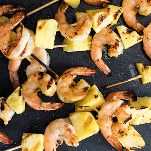 Grilled shrimp and pineapple skewers, a delicious and healthy appetizer.