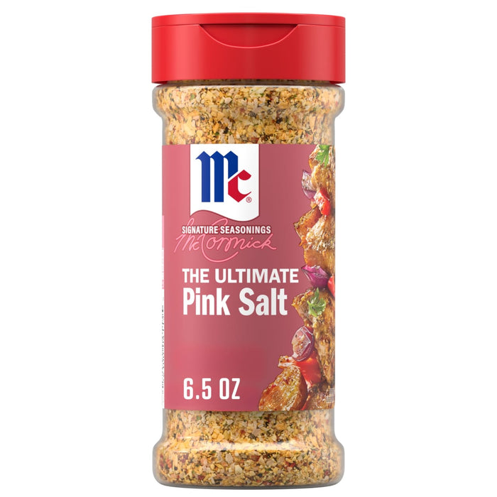 A clear plastic bottle of Mccormick Himalayan Pink Salt Pepper And Garlic Seasoning Ground 6.5 Oz featuring a red flip-top lid and a label showing roasted meat and vegetables.