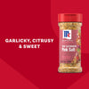 A bottle of Mccormick Himalayan Pink Salt Pepper And Garlic Seasoning Ground 6.5 Oz is displayed against a vibrant red background with text describing the flavor profile as garlicky citrusy and sweet.