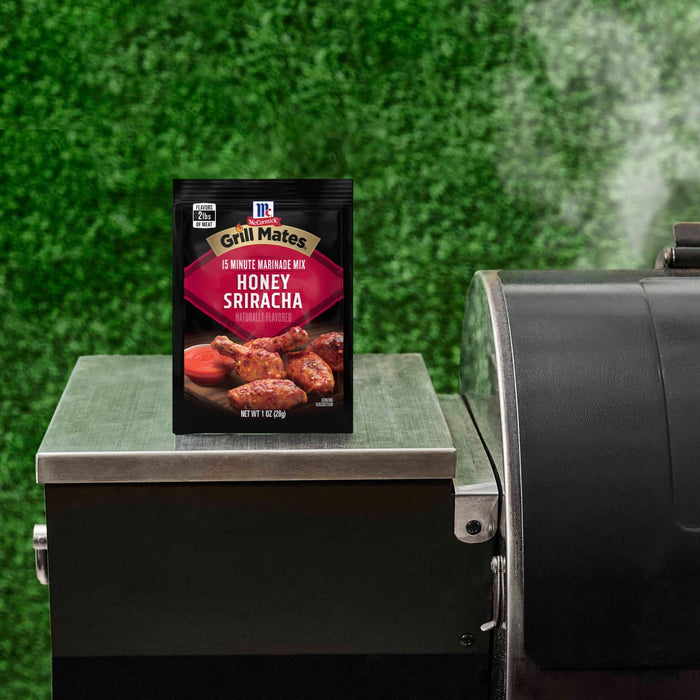 A box of McCormick Grill Mates Brown Sugar Bourbon seasoning sits on a grill.