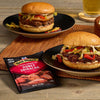 Two delicious burgers made with Hormel Real Bacon Crumbles are displayed on plates, showcasing a tasty meal option.