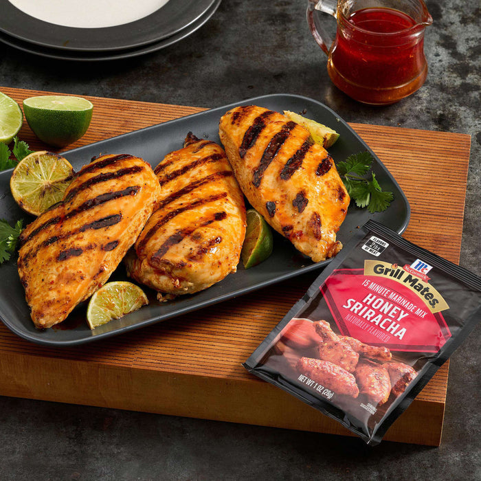 Grilled chicken breasts with lime wedges and McCormick Sweet &amp; Smoky Sriracha seasoning packet.