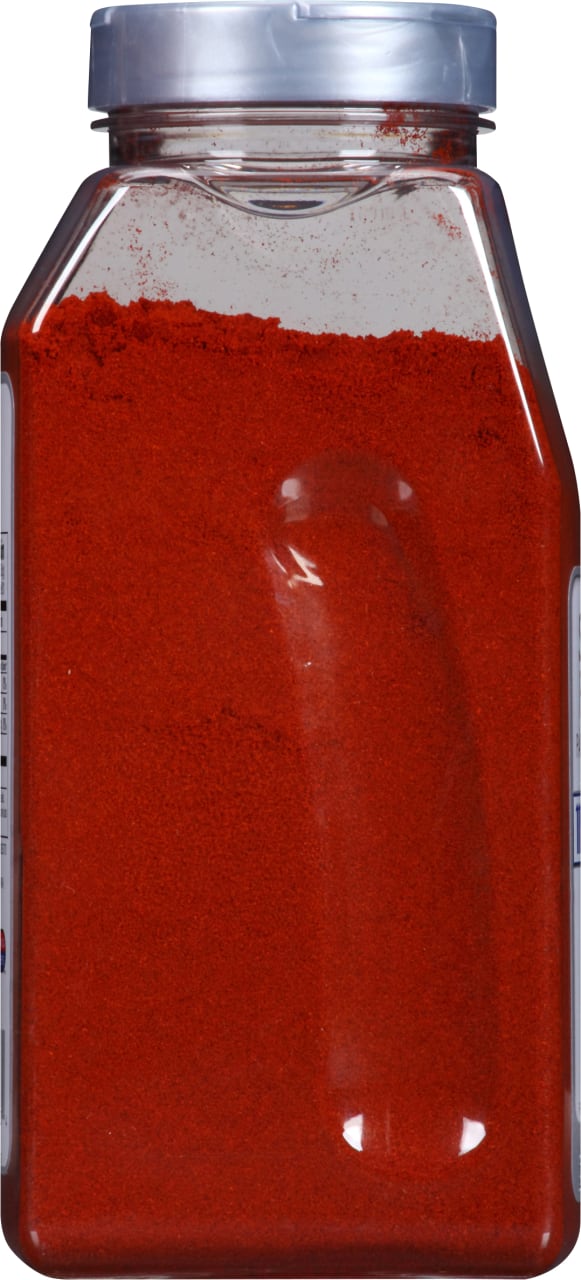 A clear plastic jar filled with red chili powder.