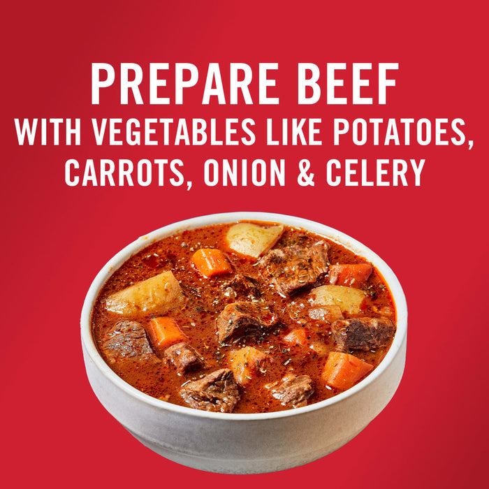 A bowl of beef stew with potatoes carrots onion and celery.