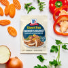 McCormick Sheet Pan Farmer's Market Chicken and Vegetables seasoning mix is displayed amidst fresh ingredients like carrots, bell pepper, and onion.