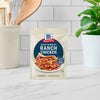 A packet of McCormick Southwest Ranch Chicken seasoning mix is displayed on a countertop.