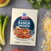 A packet of McCormick Southwest Ranch Chicken seasoning mix is displayed among fresh ingredients like lettuce, avocado, cilantro, and shredded cheese.