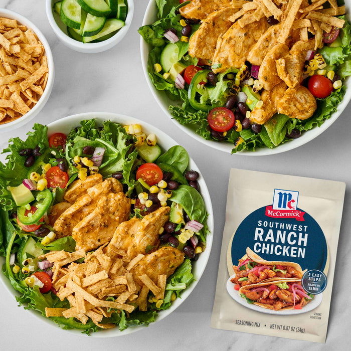 Two bowls of salad with McCormick Seasoned Ranch Chicken are displayed next to a packet of the seasoning.