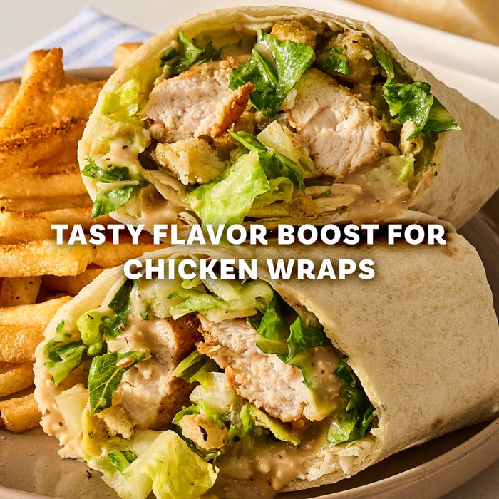 A close up of two halves of a crispy chicken wrap filled with lettuce and croutons seasoned with Mccormick Perfect Pinch Rotisserie Chicken Seasoning Powder 5 Oz served alongside golden french fries.