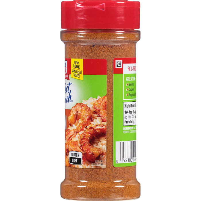 ['A bottle of McCormick Perfect Pinch Seasoning with a serving suggestion of shrimp and rice.']