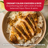 A bowl of Creamy Cajun Chicken and Rice prepared with Mccormick Perfect Pinch Cajun Seasoning Ground 5 Oz is shown in a top down view with a lime wedge and green napkin.