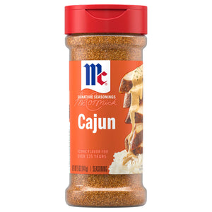 A bottle of Mccormick Perfect Pinch Cajun Seasoning Ground 5 Oz featuring a red flip-top lid and a vibrant orange label with an image of seasoned chicken over rice.