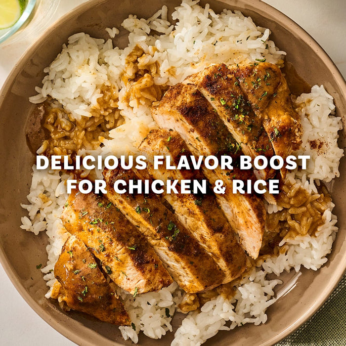 A bowl of sliced chicken breast and white rice seasoned with Mccormick Perfect Pinch Cajun Seasoning Ground 5 Oz and garnished with fresh herbs.