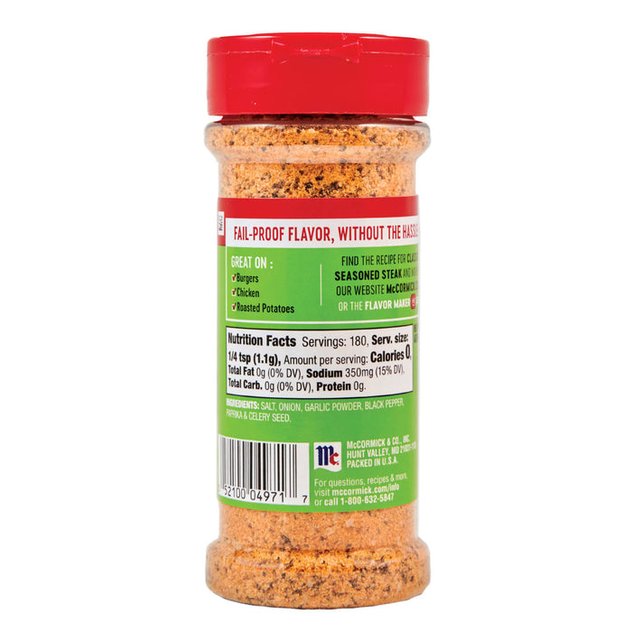 ['A McCormick Seasoned Steak spice bottle with a red lid and a green label with nutritional information.']
