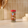 A bottle of McCormick Perfect Pinch Italian Seasoning sits on a countertop.