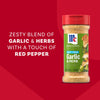 A bottle of Mccormick Garlic And Herb Seasoning Ground 4.37 Oz is displayed against a red background featuring text that describes it as a zesty blend of garlic and herbs with a touch of red pepper.