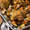 A sheet pan of roasted chicken thighs and potatoes seasoned with Mccormick Roasted Garlic And Red Bell Pepper Seasoning Ground 4.34 Oz for a flavorful one pan meal.