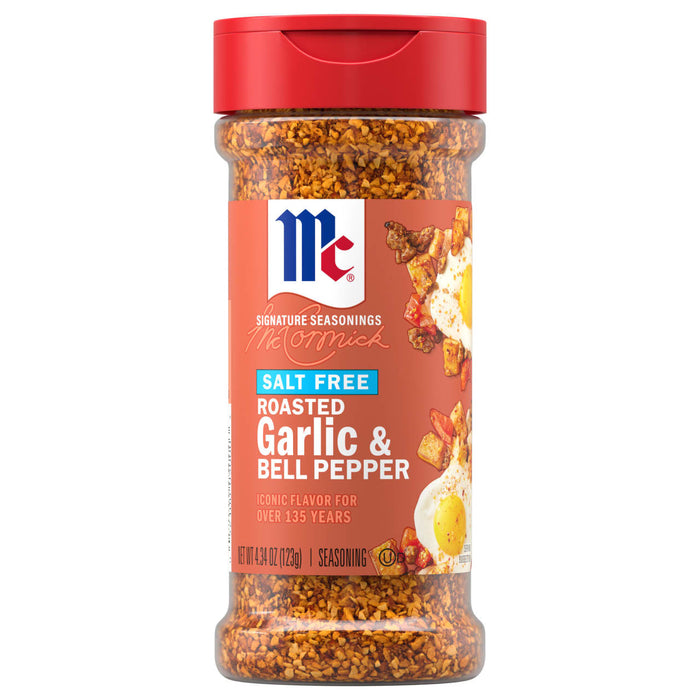 A clear plastic bottle of Mccormick Roasted Garlic And Red Bell Pepper Seasoning Ground 4.34 Oz featuring a red flip-top lid and a label showing the seasoning sprinkled over fried eggs and potatoes.