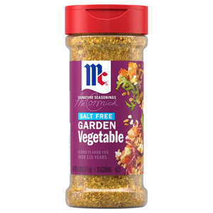 A clear bottle of Mccormick Vegetable Seasoning Assorted Form 4.16 Oz is shown, featuring a purple label with the text Salt Free Garden Vegetable and a red cap.