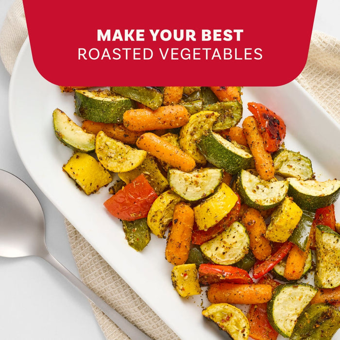 A white platter filled with vibrant roasted zucchini, yellow squash, carrots, and bell peppers seasoned with Mccormick Vegetable Seasoning Assorted Form 4.16 Oz.